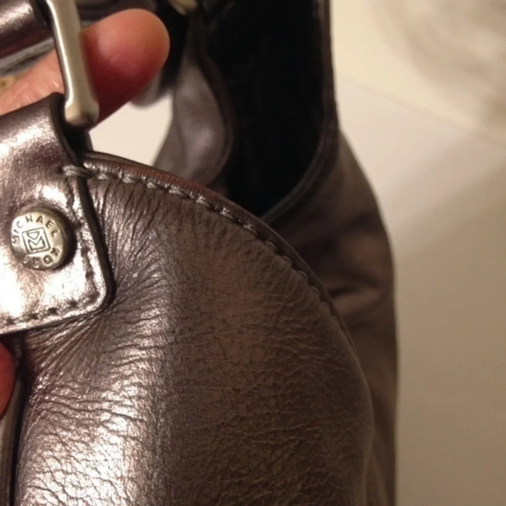 Michael Kors silver metallic hobo bag buckle